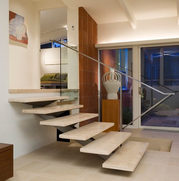 Simple metal railing complements the floating stairway perfectly