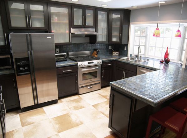 Sleek modern kitchen in black with gorgeous glass cabinets all around