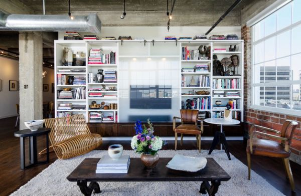 Sliding tempered glass doors with satin finish cover this custom wall unit with bookshelves