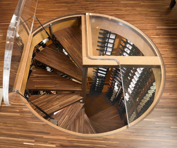 Spiral staircase leading into a wine cellar that saves up on space