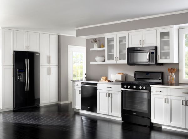 Stylish and sleek modern kitchen in white with glass cabinets