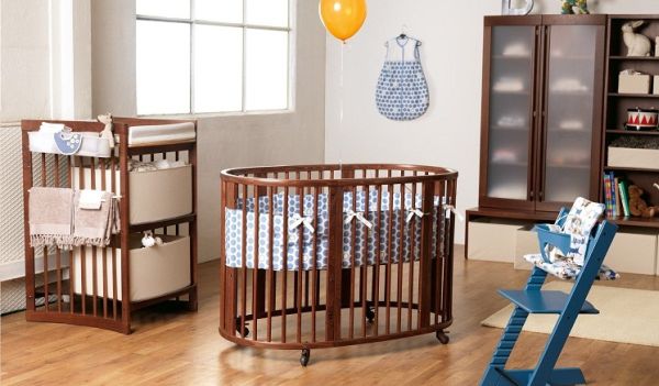 Stylish nursery space looks refined thanks to the circular crib at its heart