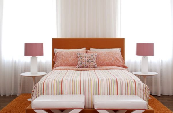 Beautiful strawberry pink and white coupled with orange in a contemporary bedroom