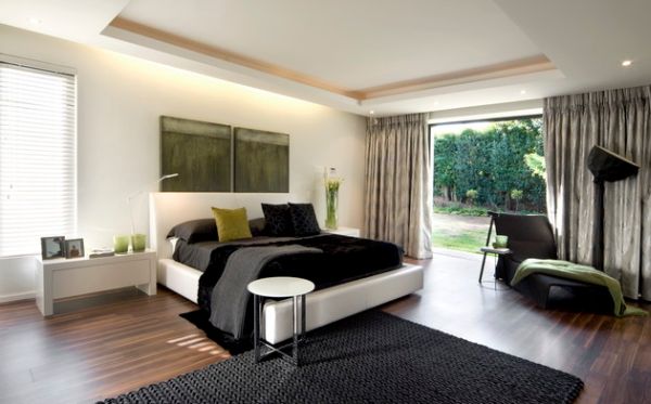 Black and white bedroom with green fabric accents in green