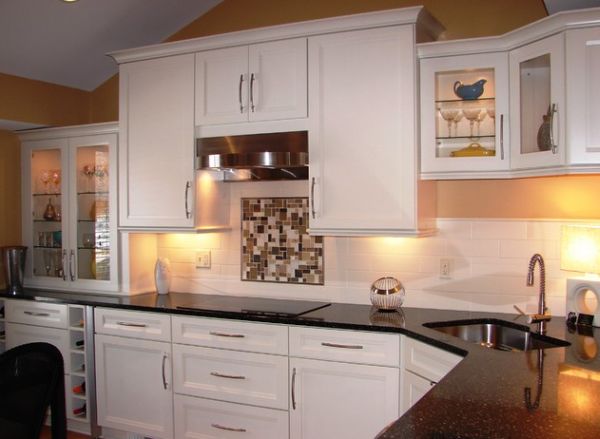 Compact Corner Sink In A Kitchen With Dark Countertop And White Cabinets 