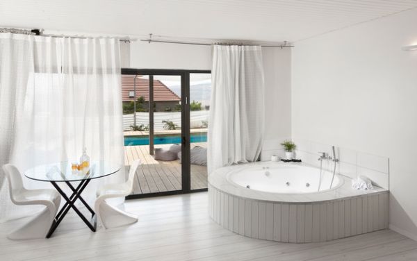 Contemporary bathroom in white with matching drapes and sliding glass doors