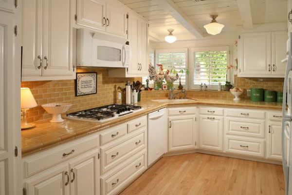 Corner sink occupies the space below the window that would have been otherwise wasted