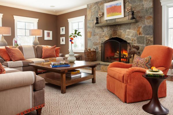 Couch in orange makes for an interesting visual when placed near a fireplace