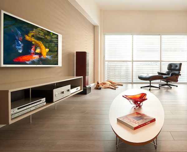 Eames elliptical table gives company to the lounger in this clean and organized living room