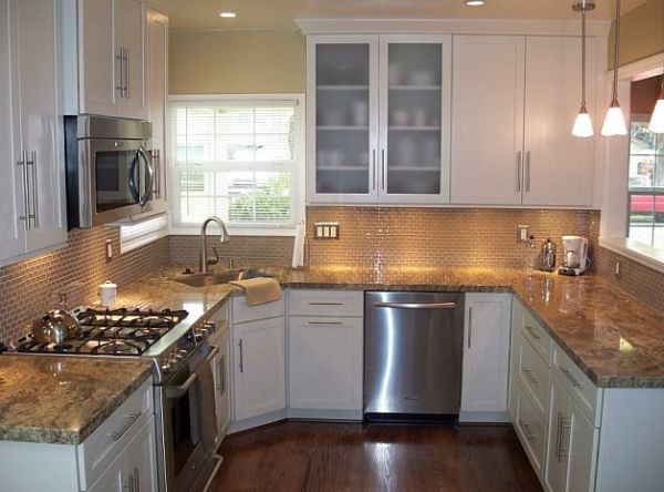 Frosted glass cabinets and a corner sink offer a unique look to this modern kitchen