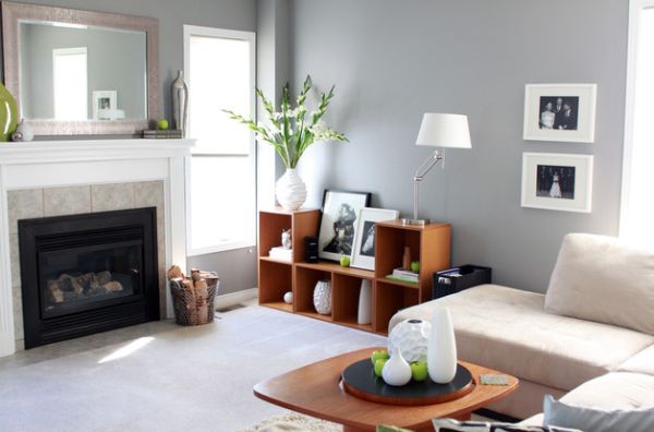 Fruit, plants and vases add green to this living room in neutral shades in an understated manner