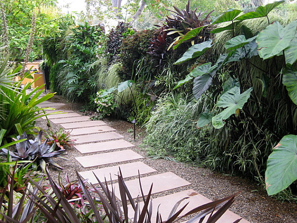 Gravel and stepping stones beside a green wall