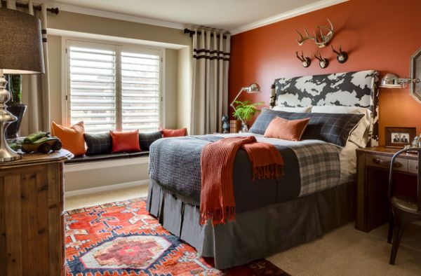 Kids' bedroom adds vivid color in the form of orange accent wall and accent fabrics