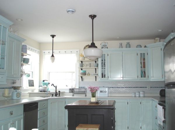 Kitchen in cool blue sports a small corner sink