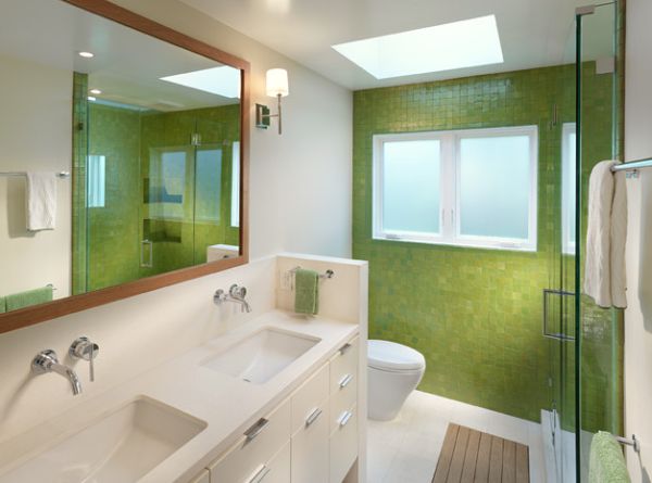 Lime green tile wall and the mirror accentuate the appeal of this bathroom