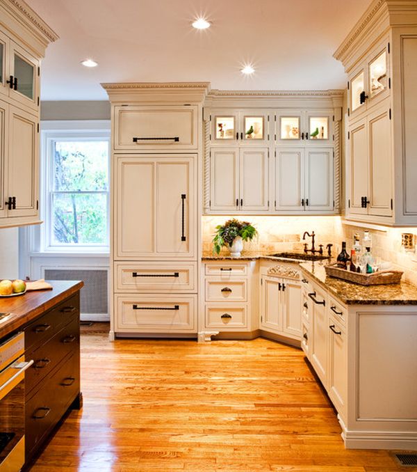 Lovely lighting accentuates the beauty of this elegant kitchen in white