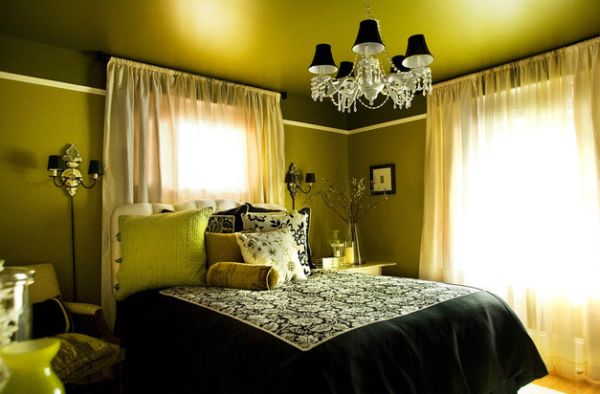 Luxurious bedroom in green uses conical lampshades in black