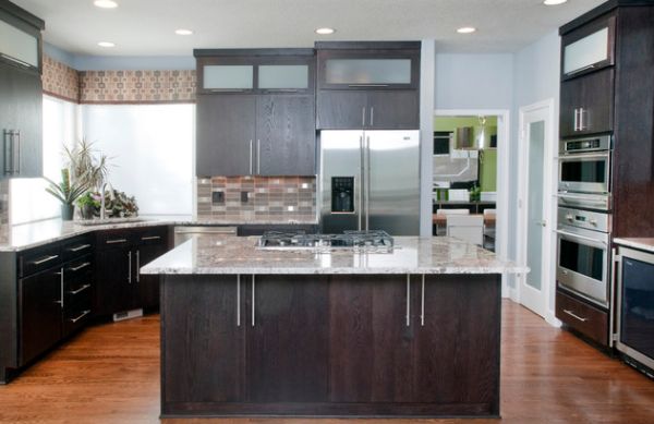 Modern kitchen with dark oak cabinetry and a compact sink in the corner