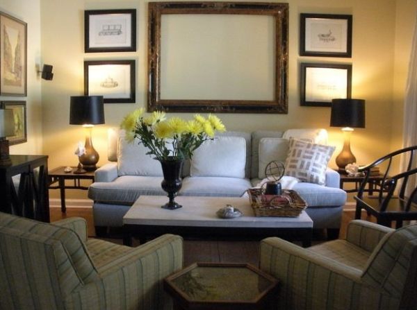 Plush couch in neutral hue flanked by table lamps sporting black lampshades