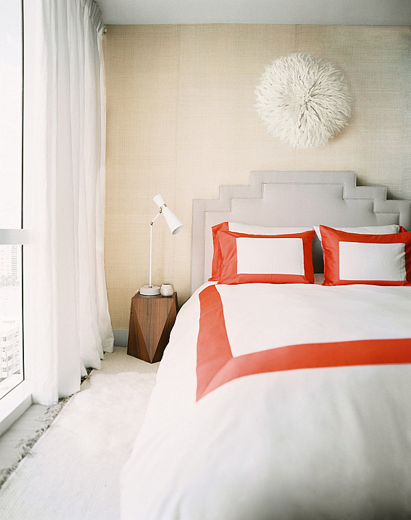 Red pops in a luxe modern bedroom