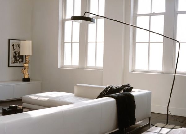 Sectional sofa in white with a low back and a floor lamp above for light