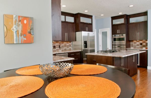 Simple additions like wall art and dining table mats can bring in orange accents