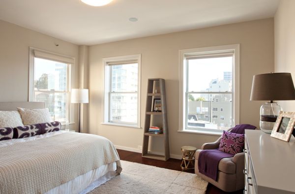 Simple use of purple pillow and rug to offer visual contrast in a neutral setting