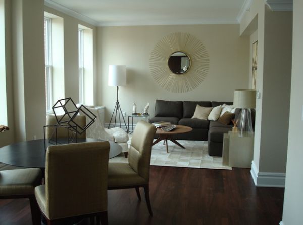 Sun dial mirror coupled with sleek floor lamp light up the room beautifully