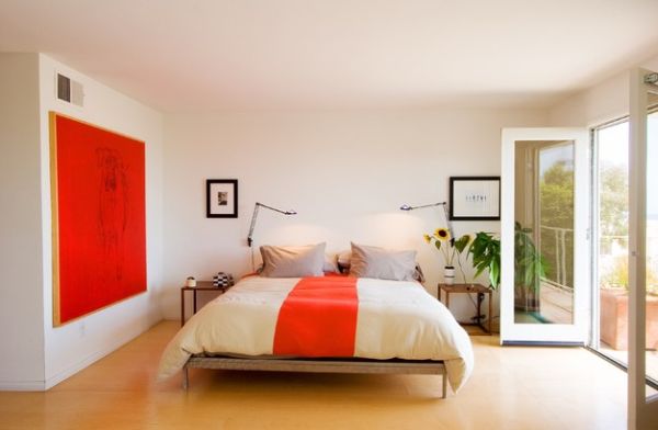 Wall art brings in a powerful punch of orange to this gorgeous bedroom