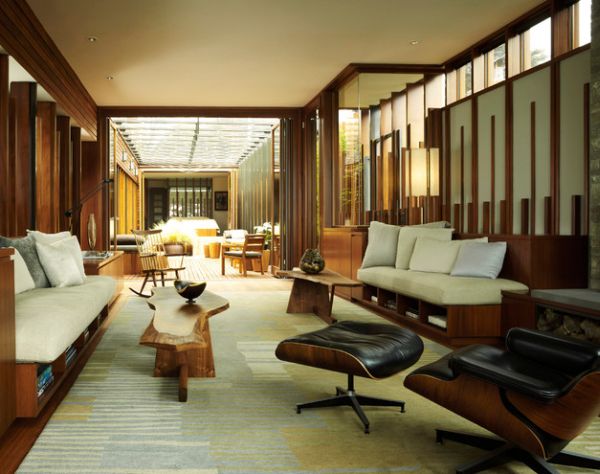 Walls of wood surround the Eames Lounge Chair and Ottoman in this living space