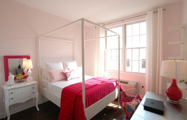 Beautiful bedroom in light pink accentuated by fabric and decor in hot fuchsia