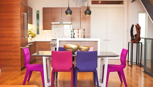 Dining space with chairs in fuchsia and violet add color to contemporary style