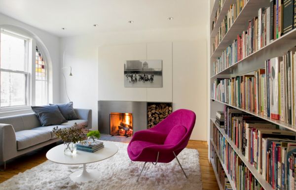 Eero Saarinen's Womb Chair in Fuchsia acts as an accent chair in a neutral setting