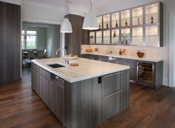 Green - gray cabinets light up this compact kitchen in a open floor plan