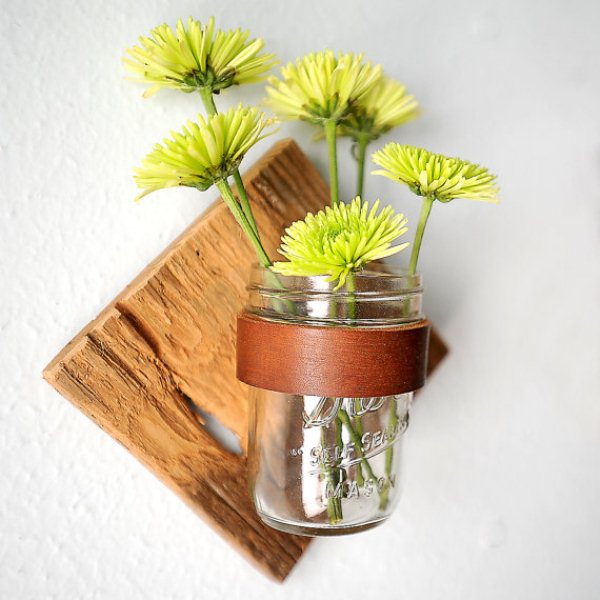Mason jar flower vase on wooden sconce