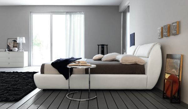 Minimalist bedroom in bluish gray with matching flooring