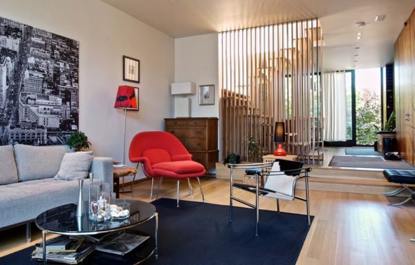 Polished modern living room sports a womb chair in red