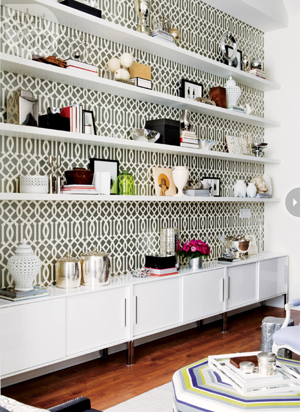 Shelving unit with black and white wallpaper backing