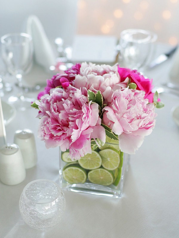 Vase centerpiece filled with fresh flowers and lime slices