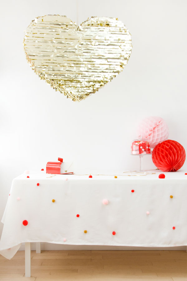 White table cloth with colorful pom poms