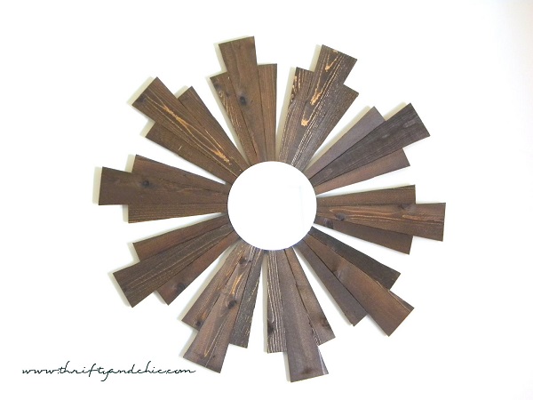 Wooden sunburst frame with circular mirror