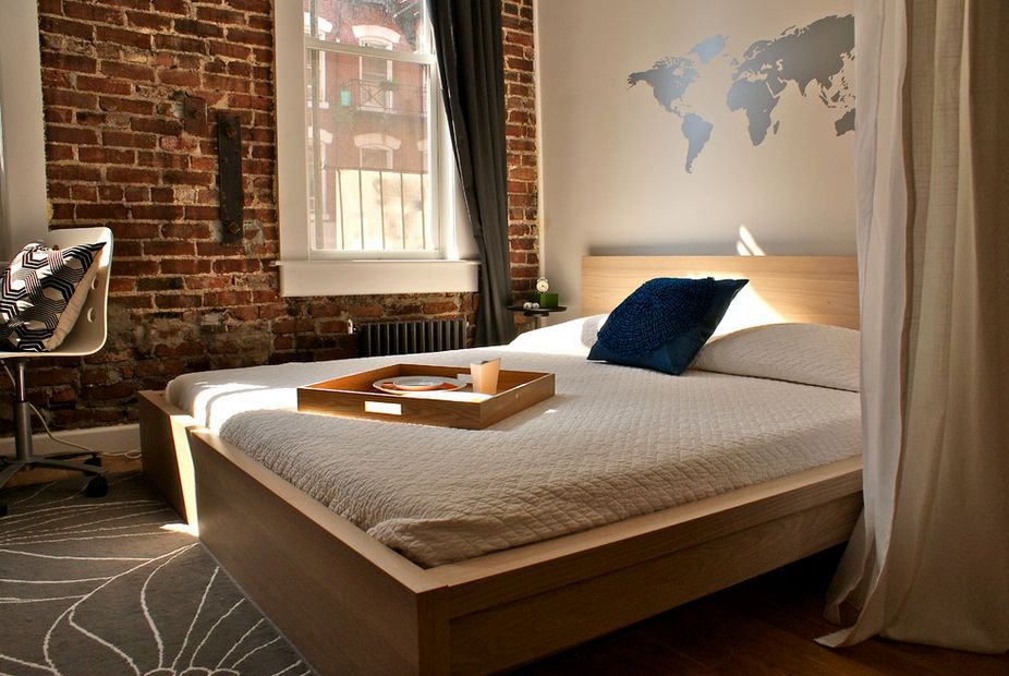 modern bedroom with exposed brick wall