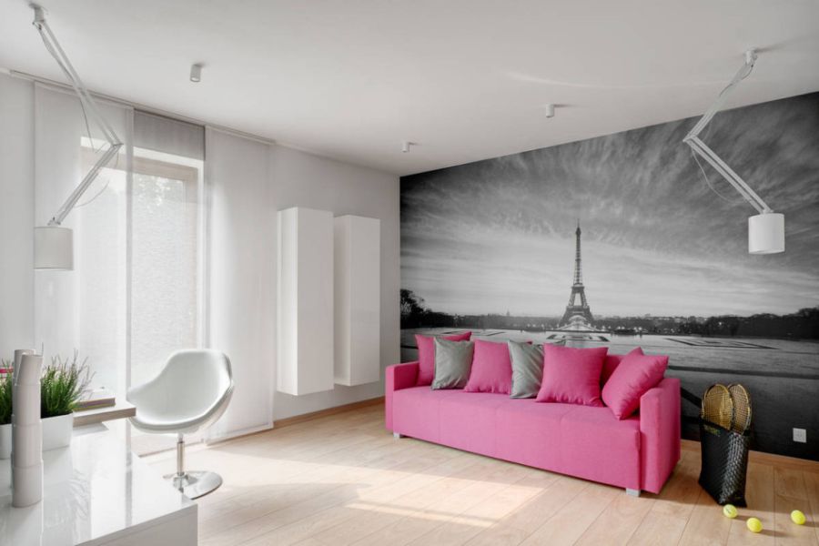 Accent couch with a mural of Paris behind it