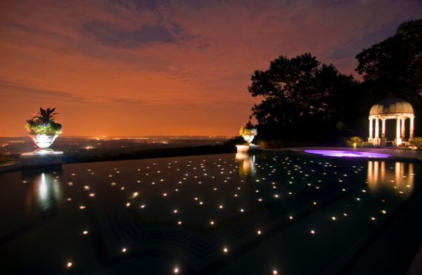 An infinity pool that appears to reflect a star-studded night sky