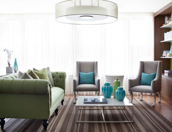 Aqua throw pillows combined effortlessly with green Chesterfield Sofa