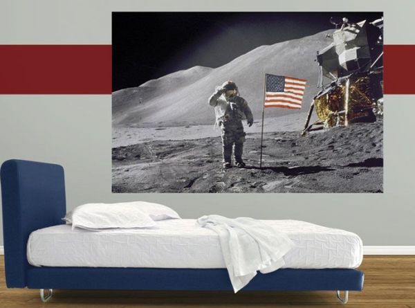 Bedroom in red, white and blue with a poster off the moon landing