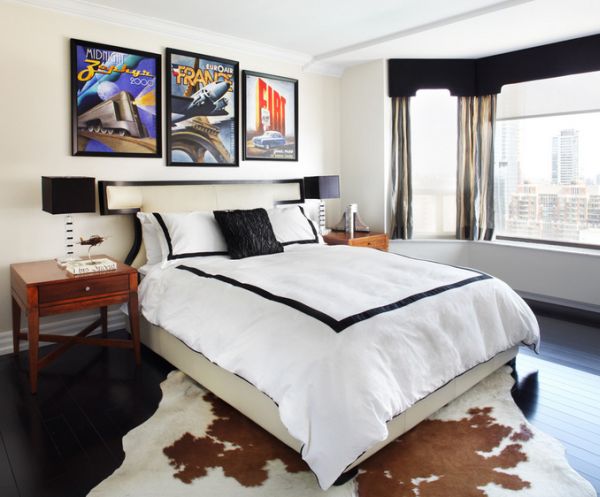 Bright posters add color to a chic contemporary bedroom in black and white