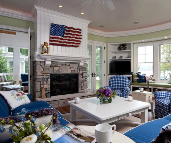 Cool blue cushions and white walls complement the flag above the fireplace elegantly