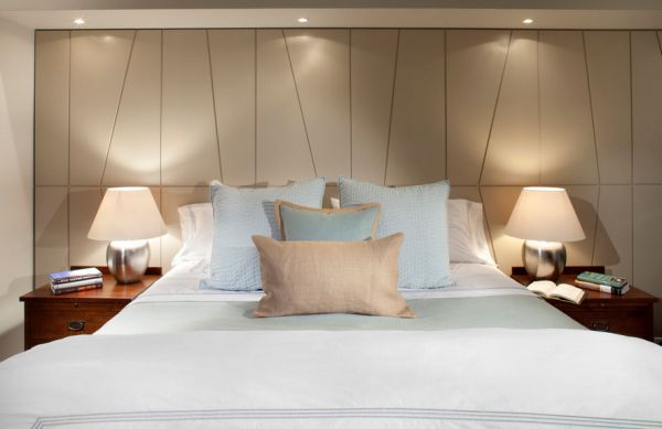 Dimmable recessed lights above the bed create a soothing atmosphere