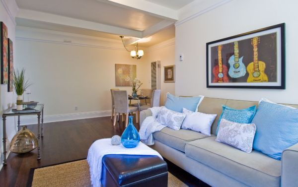 Framed guitar print above the sofa adds color to the space